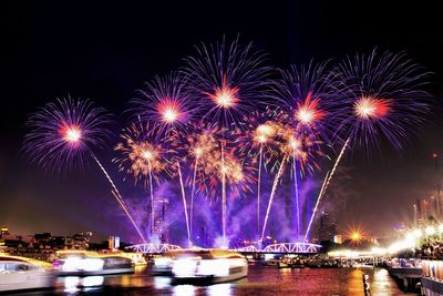 Low angle view of firework display at night