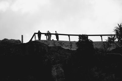 Low angle view of people standing at observation point