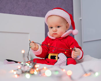 Portrait of cute girl playing with toys at home