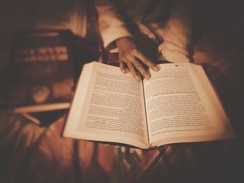 Midsection of person holding book