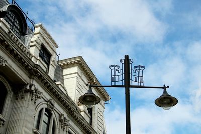 Low angle view of street and buildings against sky