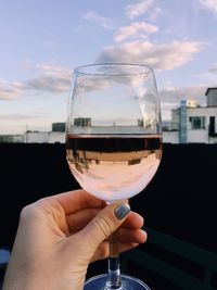 Midsection of person holding wine glass