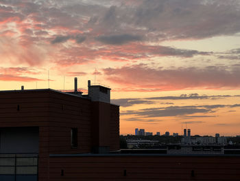 Buildings in city against sky during sunset