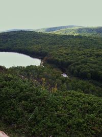 Scenic view of landscape with river in foreground