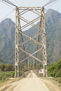 View of electricity pylon against mountain