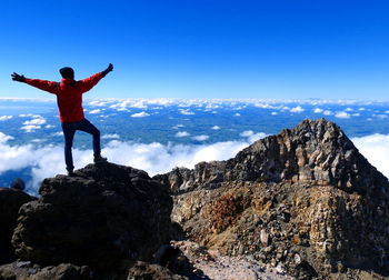 Full length of man standing on cliff against sky