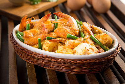 Close-up of fried tofu with shrimps on wooden table