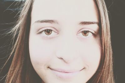 Close-up portrait of smiling young woman