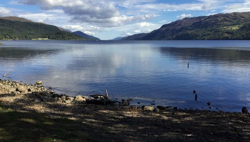 Calm lake with mountains in background