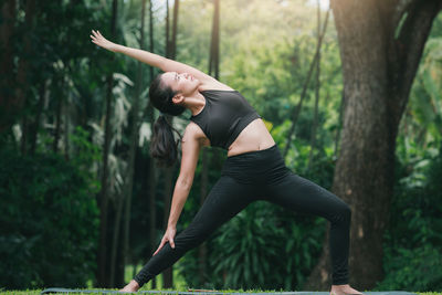 Woman exercising yoga at park