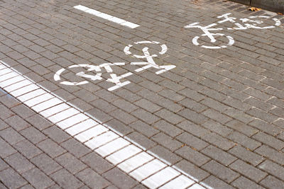 Two way cycle path, marking bike path on sidewalk, white painted bicycle sign on road on street