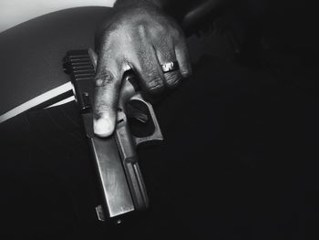 High angle view of man holding weapon