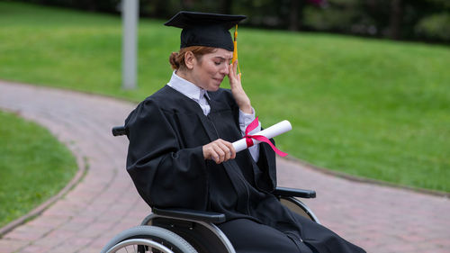 Rear view of woman wearing graduation gown