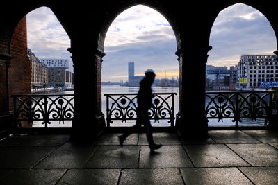 Silhouette buildings against sky in city