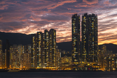 Illuminated buildings against sky at night