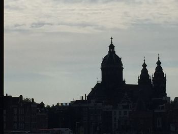 Low angle view of church against cloudy sky