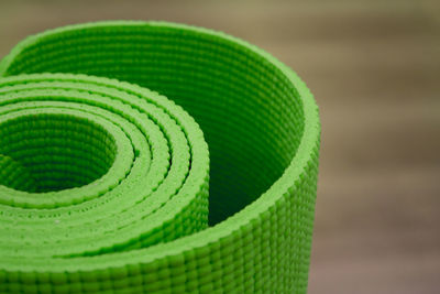 Close-up of rolled exercise mat in gym