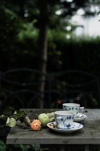 Close-up of coffee cup and fruits on table