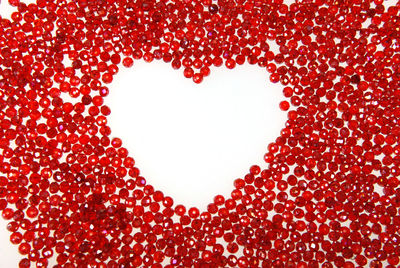 Close-up of heart shape against red background