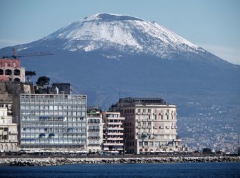 View of buildings by sea during winter