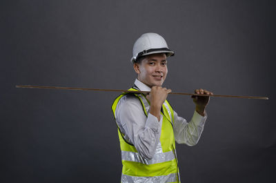 Portrait of smiling man standing against blue sky