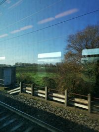 Train by railroad tracks against sky