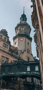 Low angle view of clock tower amidst buildings in city