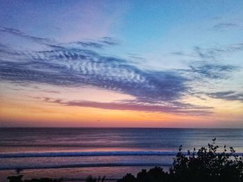 Scenic view of sea against sky at sunset