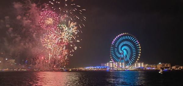 Low angle view of firework display at night