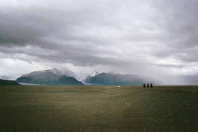 Scenic view of mountains against cloudy sky