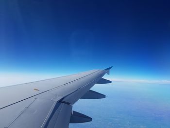 Airplane flying over blue sky
