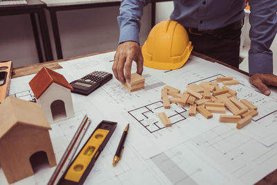 Midsection of man working on table