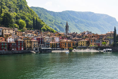 Town by river and buildings in city