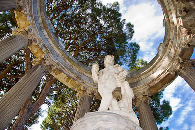 Low angle view of statue against cloudy sky