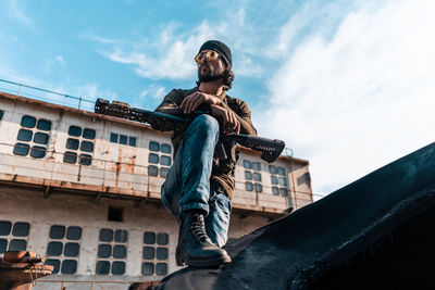 Low angle view of statue against building against sky