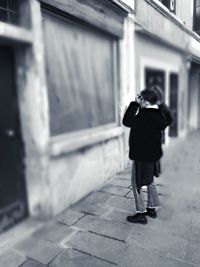 Rear view of women walking on footpath