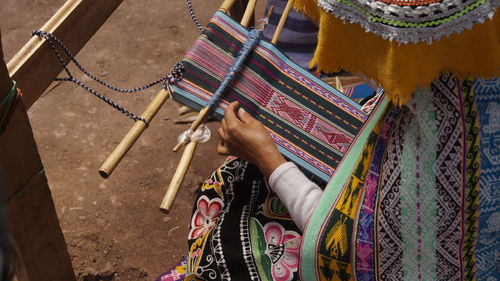 High angle view of woman working on fabric
