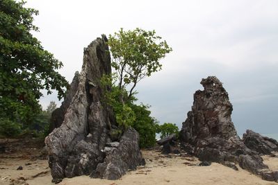 Rocks on landscape against sky