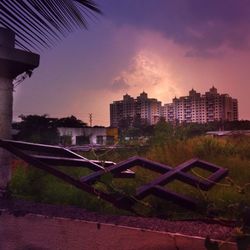 Built structures against sky at sunset