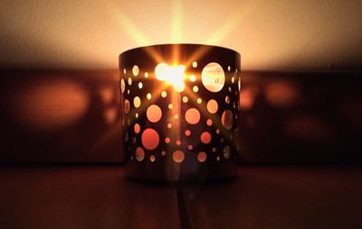 Close-up of candle in dark room