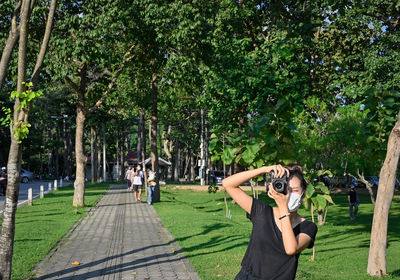 Series photo of young women with camera in public park outdoor on sunny day