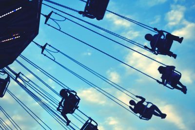 Low angle view of silhouette ferris wheel against sky