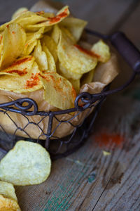 Close-up of potato chips in container on table