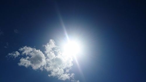 Low angle view of bright sun in sky