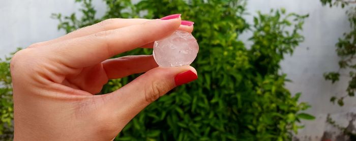 Close-up of cropped hand holding ice 