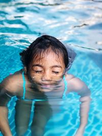 Portrait of a girl swimming in pool