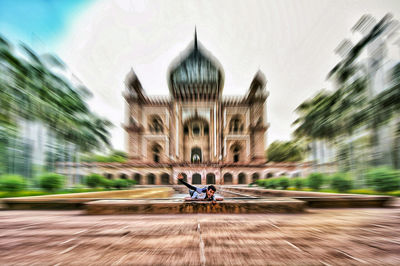 Blurred motion of man riding motorcycle on road