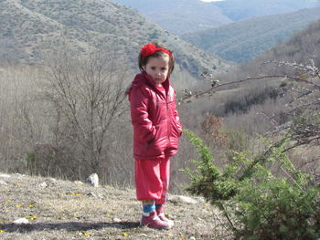 Full length portrait of girl standing on mountain