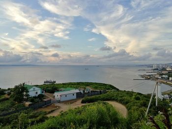 High angle view of sea and buildings against sky