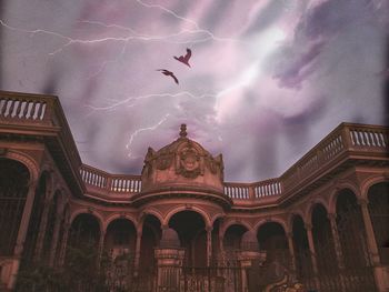 Low angle view of historic building against cloudy sky